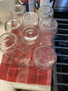 quart glass jars draining upside down on a towel