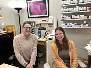 Two smiling ladies in an office